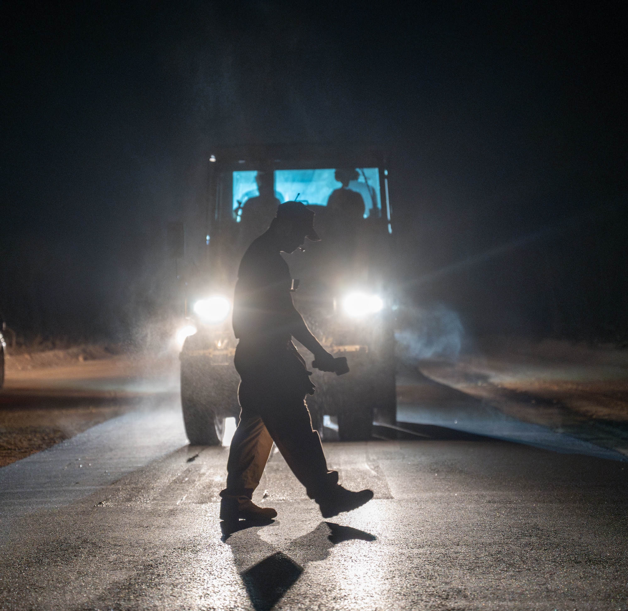 U.S. Air Force Senior Airman Elvin Dom, 513th Expeditionary Rapid Engineer Deployable Heavy Operations Repair Squadron Engineers Squadron heavy construction pavement and equipment, uses a temperature gun to make sure the fresh asphalt is at the right temperature to compact at Tinian North Airfield, Tinian, Feb. 05, 2025. The 513th Expeditionary Red Horse Squadron serves as a vital community partner on Tinian, delivering economic benefits and advancing infrastructure improvements throughout the island. (U.S. Air Force photo by Airman 1st Class Manasseh Demissie)