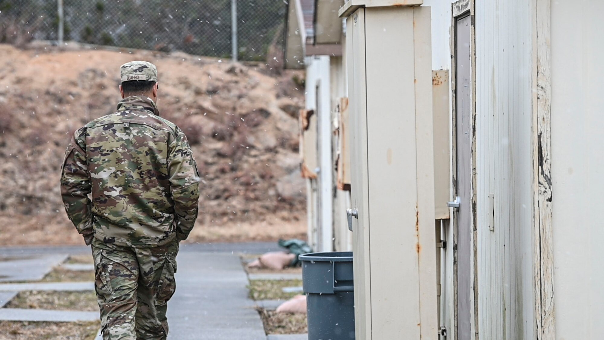 U.S. Air Force Tech. Sgt. Bertie Quai Hoi, 51st Force Support Squadron personnel contingency operation team lead, walks outside contingency dorms for agile combat employment operations at Kunsan Air Base, Republic of Korea, Jan. 27, 2025. The dorms will house Airmen from the 51st Fighter Wing in support of an ACE movement during exercise Beverly Herd 25-2. (U.S. Air Force photo by Staff Sgt. Ashley N. Mikaio)
