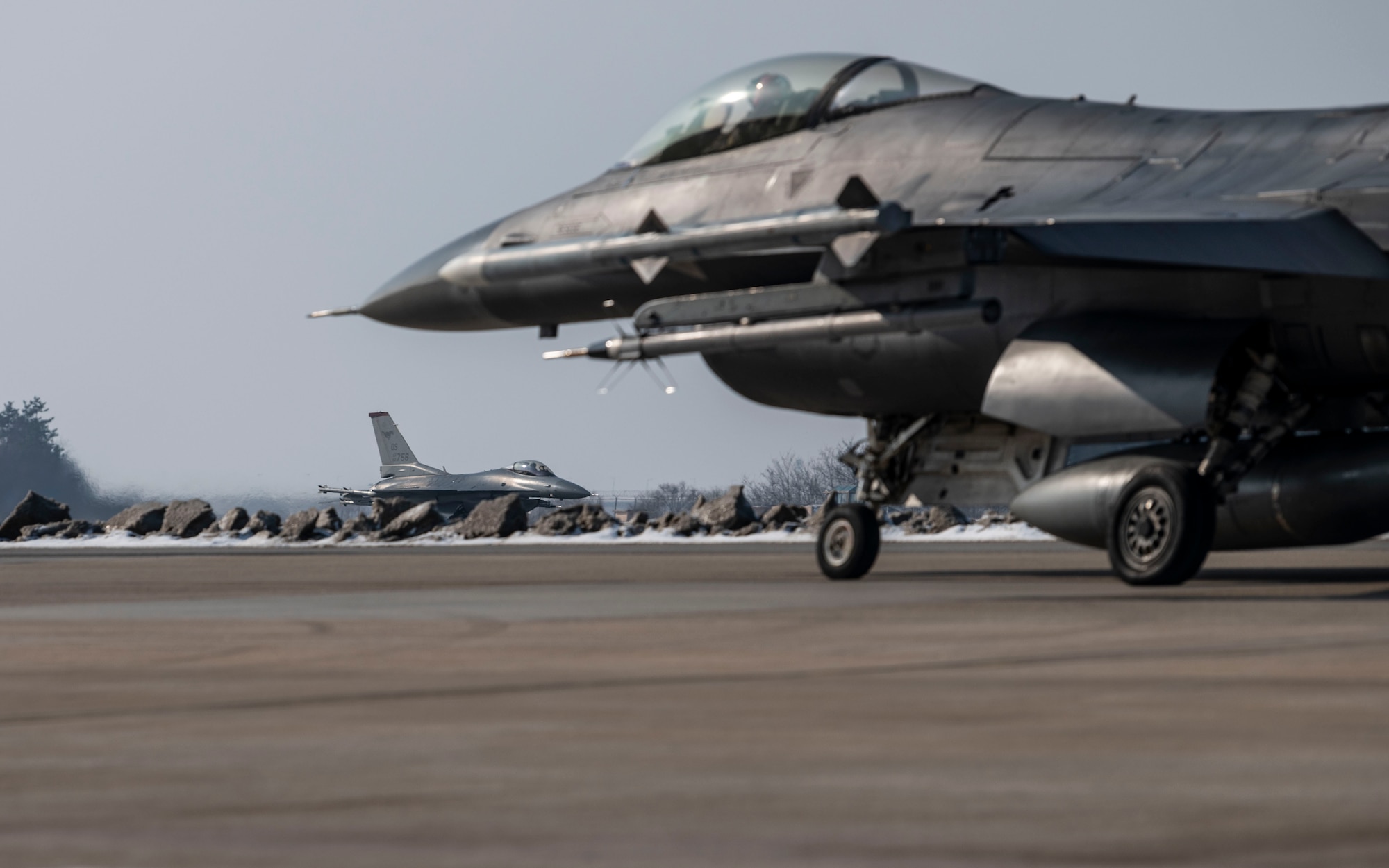 Two U.S. Air Force F-16 Fighting Falcons assigned to the 36th Fighter Squadron prepare for take off from Kunsan Air Base, Republic of Korea, to return to Osan AB, Jan. 30, 2025. The F-16s operated out of Kunsan AB to support agile combat employment capabilities for exercise Beverly Herd 25-2. The 51st Fighter Wing exercise, BH 25-2, is intended to affirm the wing’s ability to survive and operate in a contested Korean Theater environment while simultaneously supporting core mission essential tasks in another location. (U.S. Air Force photo by Staff Sgt. Ashley N. Mikaio)