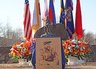 A statue and wood portrait of Capt. Lewis Millett at the 74th anniversary of the Battle of Bayonet Hill Commemoration Ceremony held at Osan Air Base, South Korea, Feb. 20, 2025.