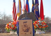 A statue and wood portrait of Capt. Lewis Millett at the 74th anniversary of the Battle of Bayonet Hill Commemoration Ceremony held at Osan Air Base, South Korea, Feb. 20, 2025.