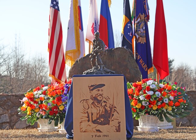 A statue and wood portrait of Capt. Lewis Millett at the 74th anniversary of the Battle of Bayonet Hill Commemoration Ceremony held at Osan Air Base, South Korea, Feb. 20, 2025.