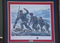 A portrait of Capt. Lewis Millett leading "Easy Company" is displayed at the 74th anniversary of the Battle of Bayonet Hill Commemoration Ceremony held at Osan Air Base, South Korea, Feb. 20, 2025.