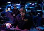 U.S. Navy Lt. Hayden Mason, the tactical action officer aboard the Arleigh Burke-class guided-missile destroyer USS Shoup (DDG 86), mans a watch station in the ship’s combat information alongside Japan Maritime Self-Defense Force sailors from the Maya-class guided-missile destroyer JS Haguro (DDG 180) during Fleet Synthetic Training-Joint (FST-J) 25-71 (Resilient Shield), Feb. 24. Fleet Synthetic Training-Joint (FST-J) 25-71 (Resilient Shield) is an annual computer-generated exercise focused on Ballistic Missile Defense (BMD), designed to integrate and hone warfighting skills collectively in a tactically demanding environment. (U.S. Navy photo by Mass Communication Specialist 1st Class Brian G. Reynolds)