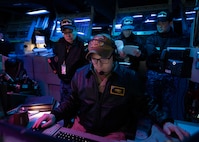 Sailors from the Japan Maritime Self-Defense Force observe operations in the combat information center aboard USS Shoup (DDG 86) during Fleet Synthetic Training-Joint (FST-J) 25-71 (Resilient Shield).