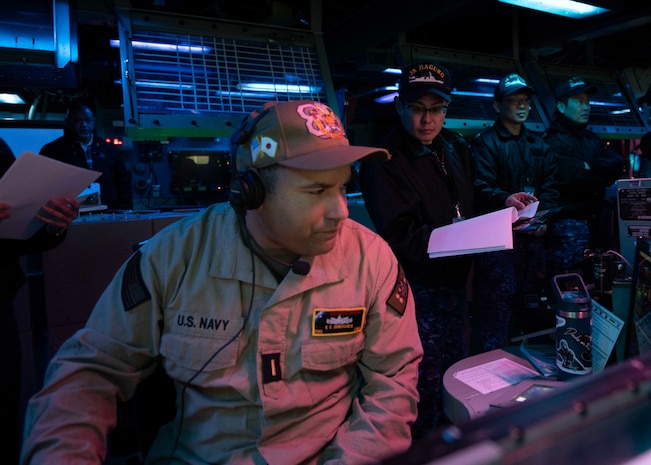 Sailors from the Japan Maritime Self-Defense Force observe operations in the combat information center aboard USS Shoup (DDG 86) during Fleet Synthetic Training-Joint (FST-J) 25-71 (Resilient Shield).