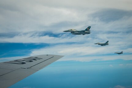 Three Indonesian Air Force (IDAF) F-16 Fighting Falcon's fly alongside a Hawaii Air National Guard KC-135 Stratotanker assigned to the 203rd Air Refueling Squadron during an air-to-air refueling training mission over Indonesia, Feb. 17, 2025.