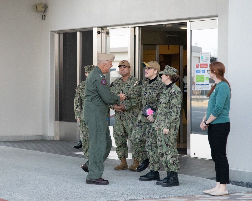 U.S. Navy Vice Adm. Daniel Cheever, Commander of Naval Air Forces, U.S. Pacific Fleet, and an Illinois native, shakes hands with leadership from Naval Family Branch Clinic Iwakuni during a base tour at Marine Corps Air Station Iwakuni, Japan, Feb. 20, 2025. Vice Adm. Daniel Cheever and his staff visited MCAS Iwakuni while touring the IndoPacific to ensure MCAS Iwakuni Sailors have the proper resources to complete the mission of Naval aviation. (U.S. Marine Corps photo by Cpl. Colin Thibault)