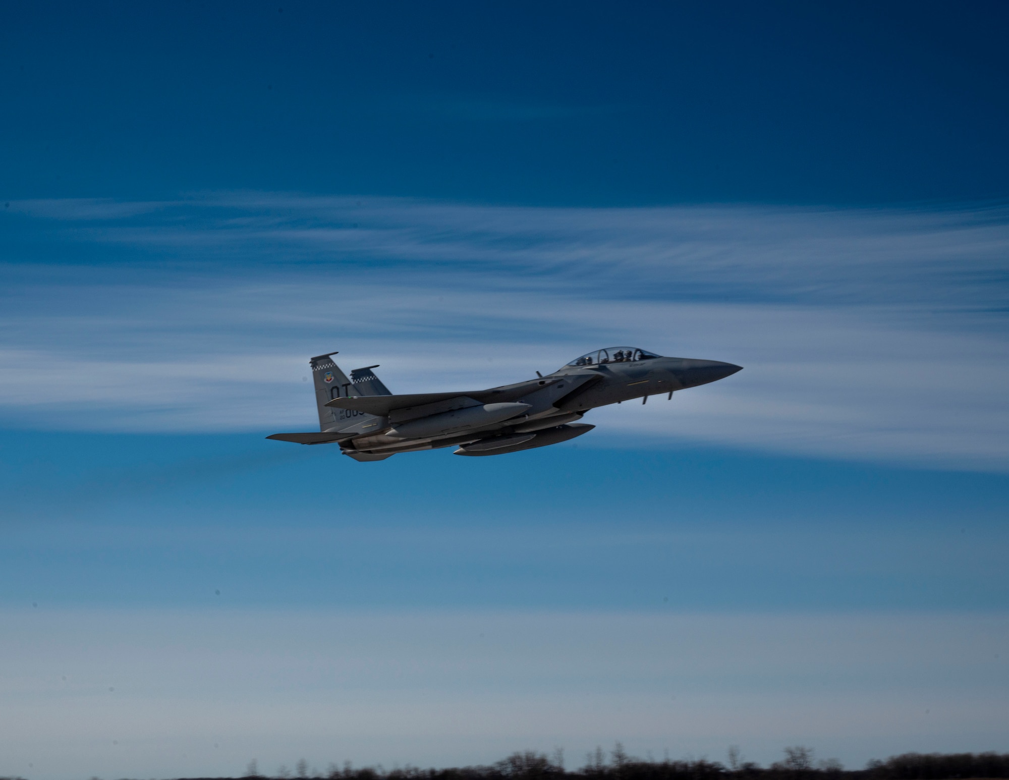 An F-15 EX Eagle II assigned to the 53rd Wing at Eglin Air Force Base, Fla., flies over the runway at Grand Forks AFB, N.D., Feb. 19, 2025.