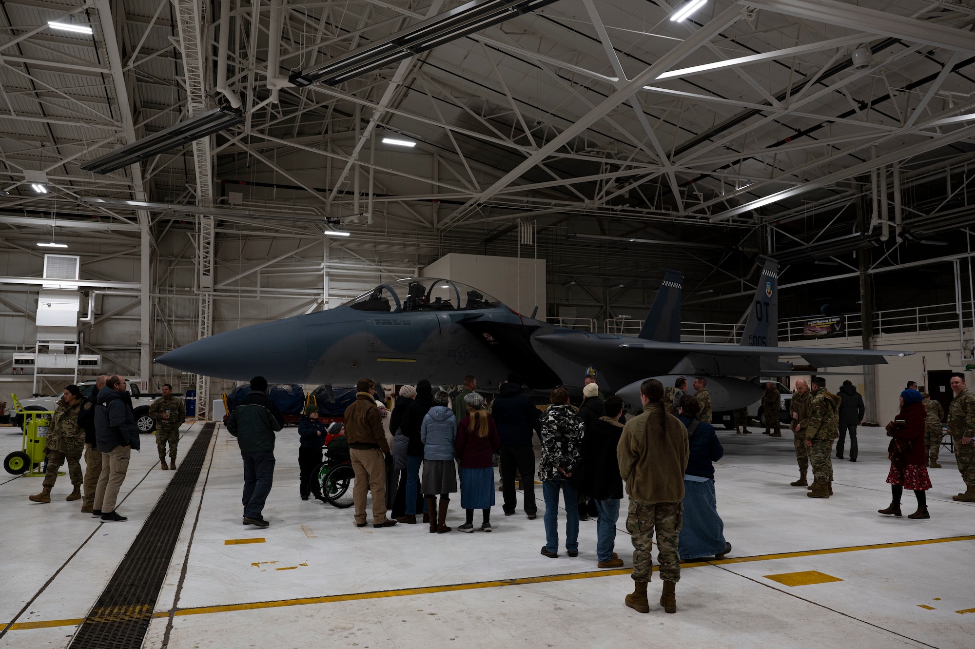Airmen and civilians gather around an F-15 EX Eagle II assigned to Eglin Air Force Base, Fla., during a tour commemorating Project Streak Eagle and world record setting airframes at Grand Forks AFB, N.D., Feb. 20, 2025.