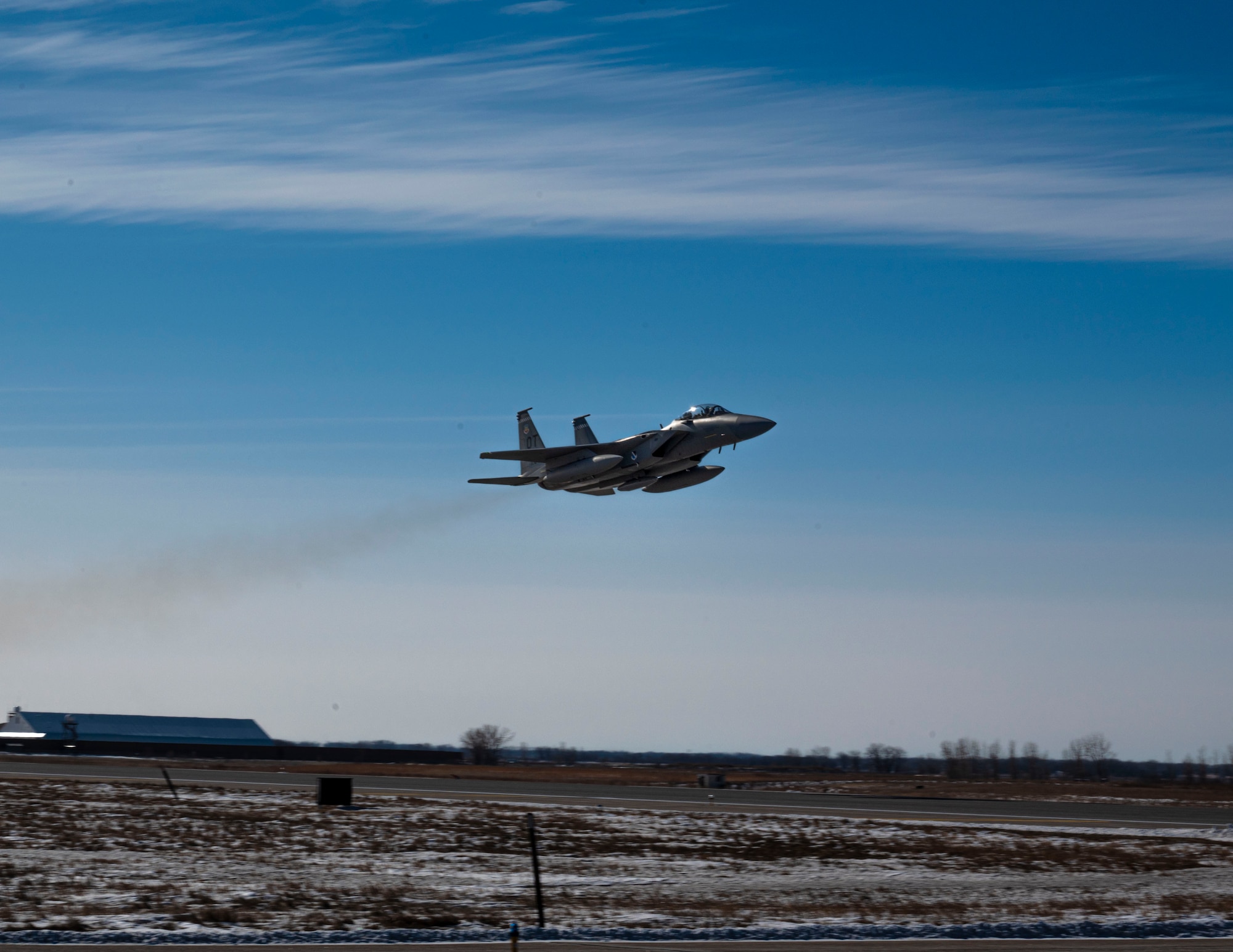 An F-15 EX Eagle II assigned to the 53rd Wing at Eglin Air Force Base, Fla., flies over the runway at Grand Forks AFB, N.D., Feb.19, 2025.