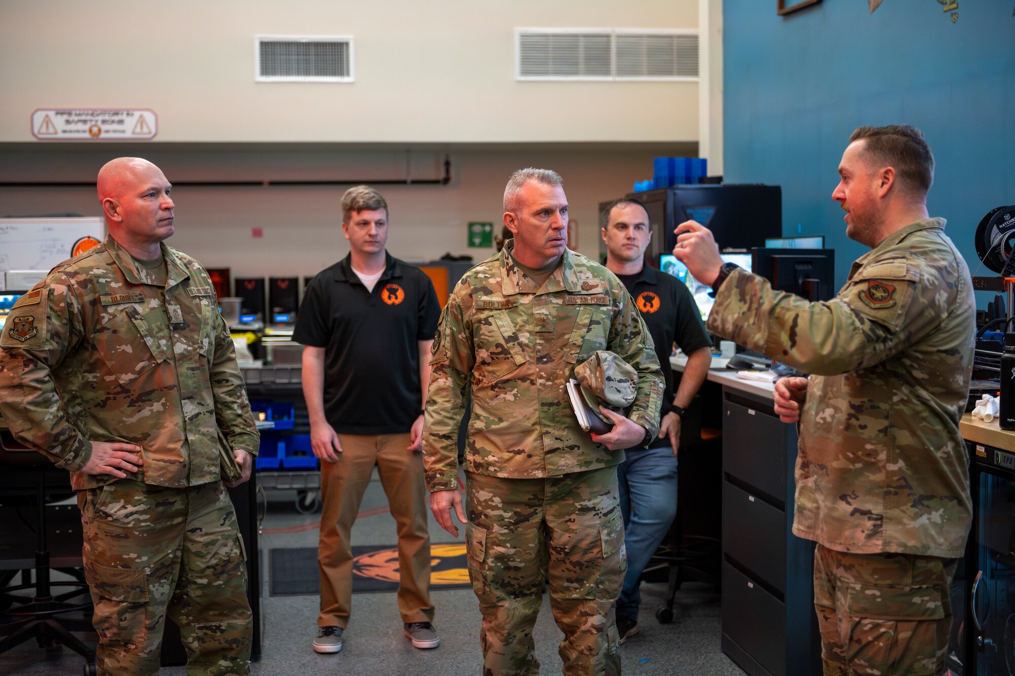 A U.S. Air Force Gen. watches a 3-D printing demonstration