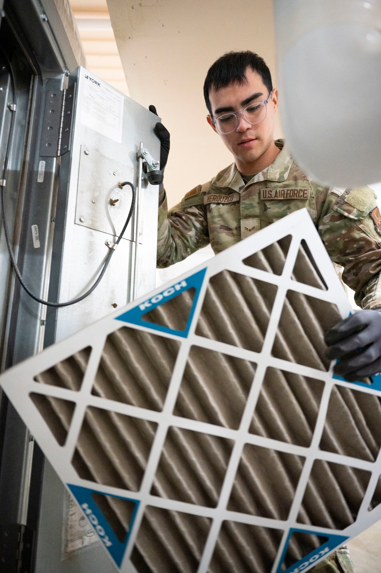 Airman 1st Class Jose Verduzco, a 5th Civil Engineer Squadron heating, ventilation, air conditioning and refrigeration specialist, removes an old filter from an air handling unit at the Child Development Center on Minot Air Force Base, North Dakota, Feb. 19, 2025. These specialists are responsible for the installation, maintenance and operation of HVAC/R systems and equipment necessary for Airmen to complete operations in a variety of climates all over the world. (U.S. Air Force photo by Senior Airman Kendra A. Ransum)
