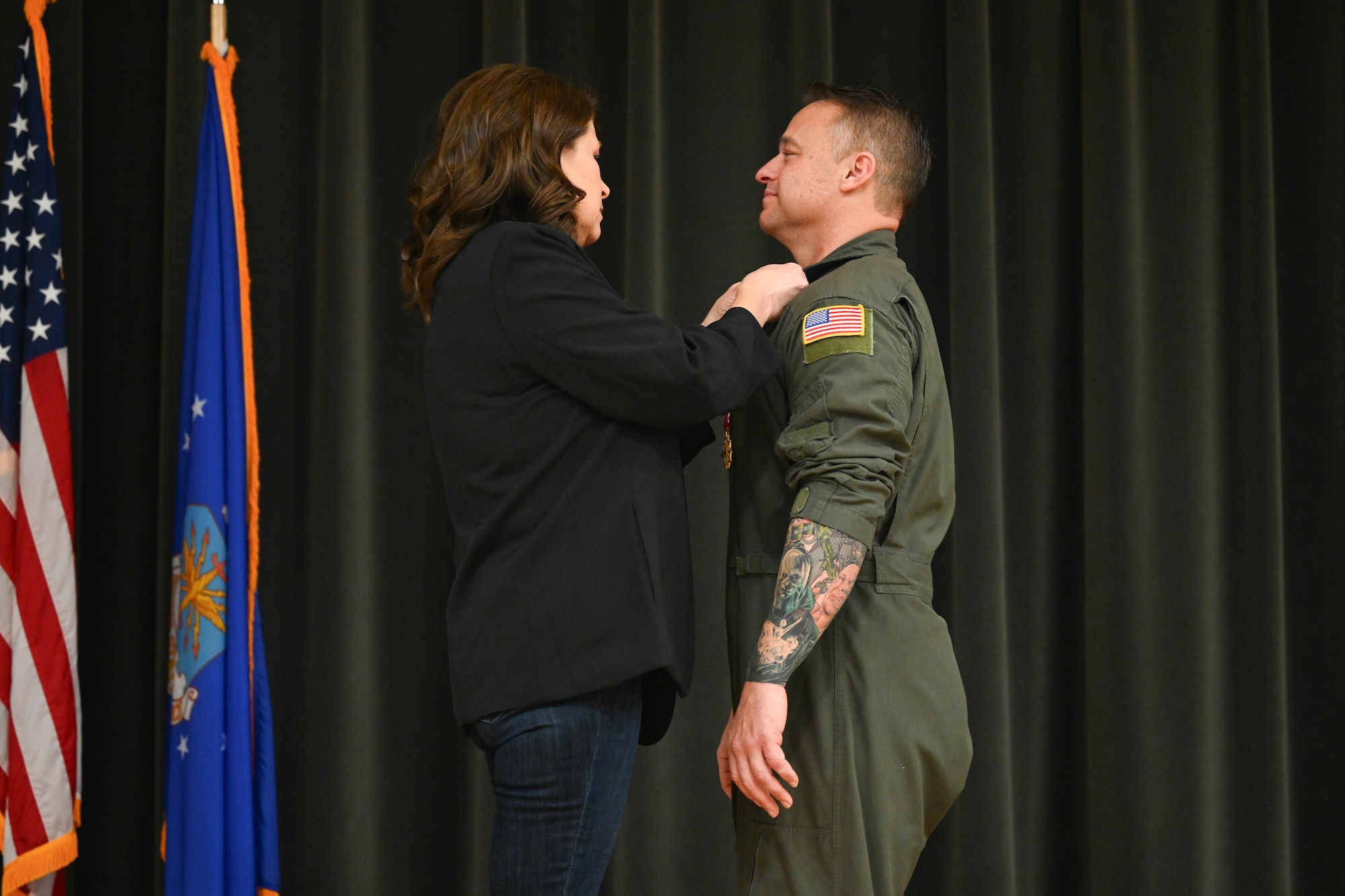 Woman places a pin on a man.