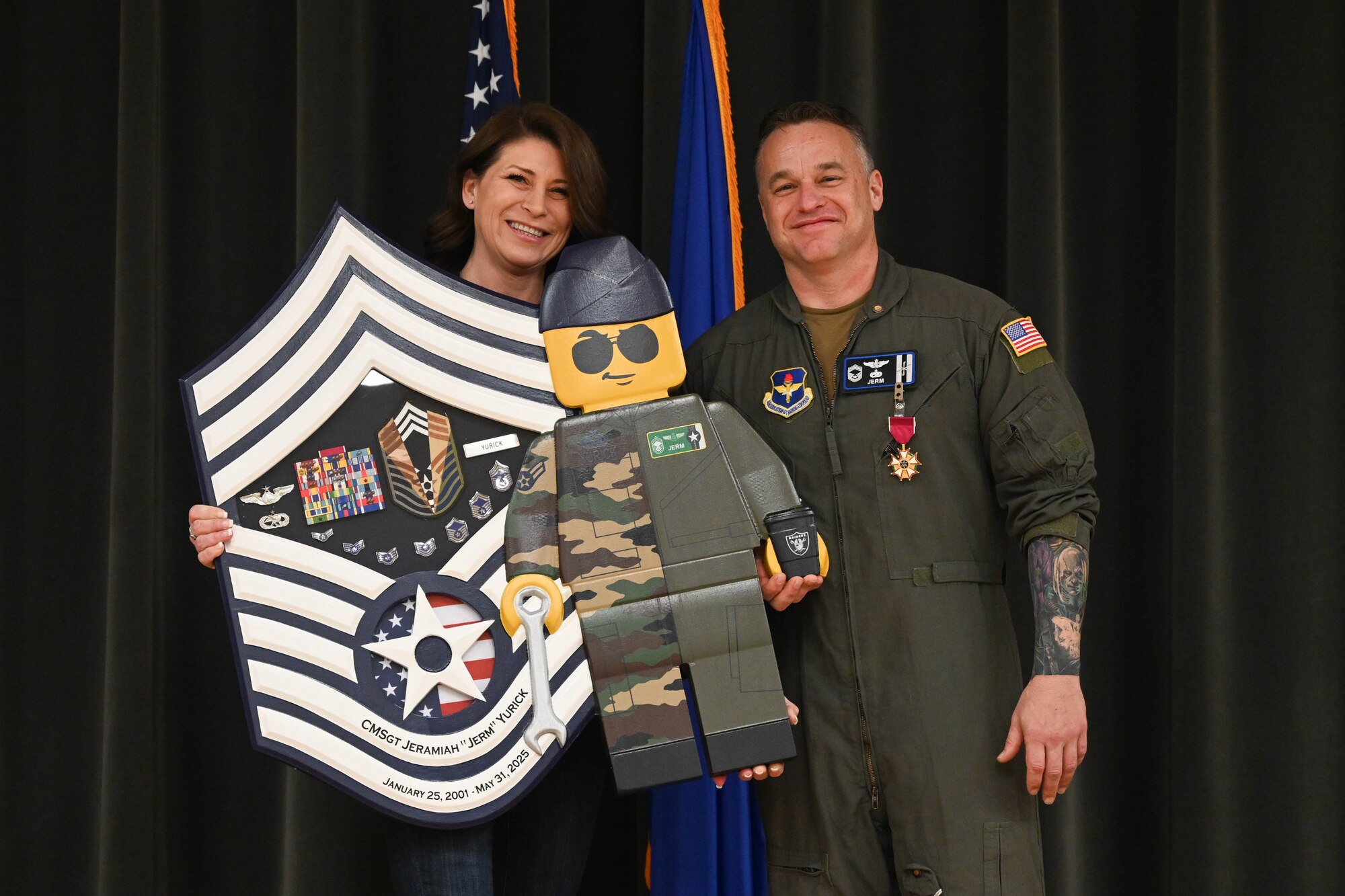 A man and woman stand on stage.