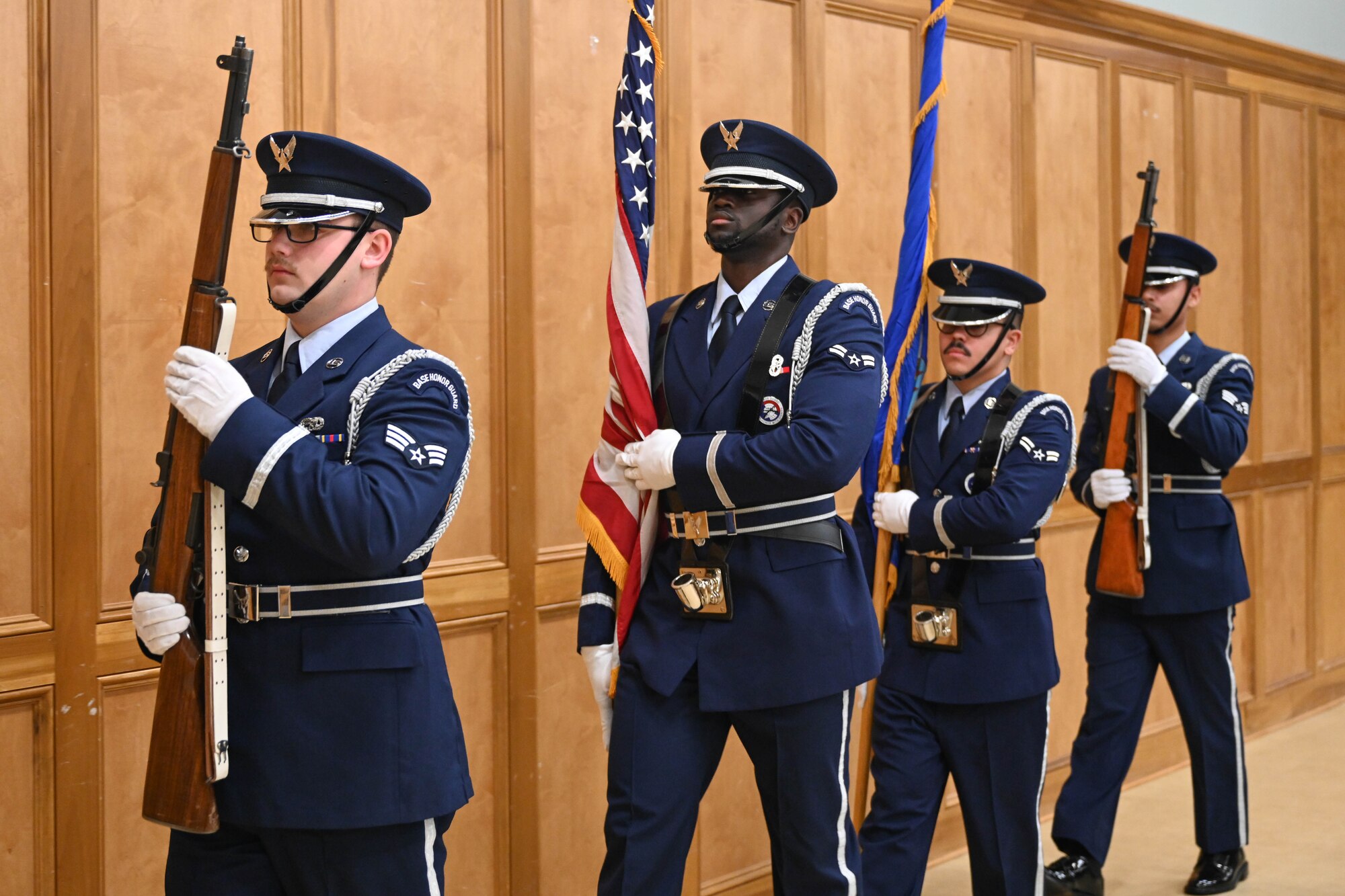 Airmen in uniform march together.