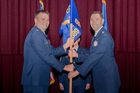 Col. Richard Wallace, 960th Cyberspace Operations Group commander, hands the 689th Network Operations Squadron guidon to Lt. Col. Jason Brosseau, signifying his assumption of command of the 689th NOS, December 6, 2024, at Maxwell Air Force Base-Gunter Annex, Alabama. The 689th NOS is a geographically separated unit of the 960th COG located at Joint Base San Antonio-Chapman Training Annex, Texas. (Courtesy photo from SrA Pratyush Gupta)