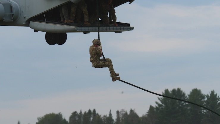 2nd Lt. Kyle Funk, military police officer, 323rd Military Police Company, conducts fast rope insertion and extraction system training out of a CH-53K King Stallion helicopter during Exercise Northern Strike at Alpena Combat Readiness Training Center, Alpena, Mich., Aug. 5, 2024. Fast-roping is a technique for descending a thick rope, allowing troops to deploy from a helicopter in places where the aircraft cannot touch down.