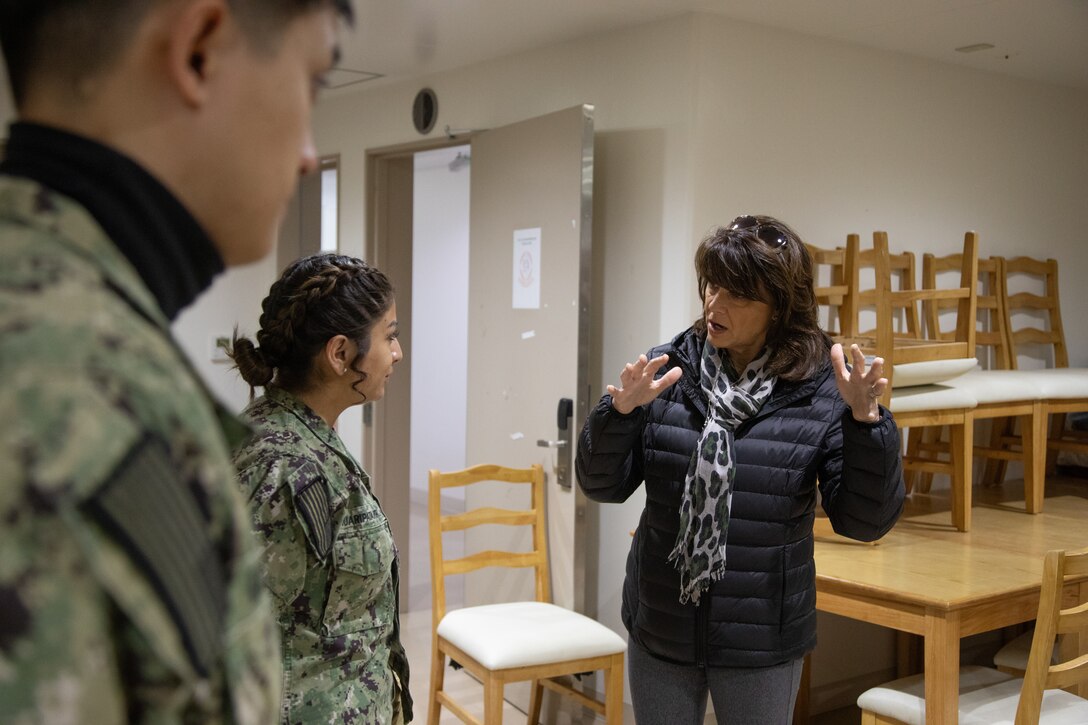 Julee Cheever, spouse of the Commander, Naval and forces and Commander Naval Air Forces, Pacific Fleet, speaks with U.S. Sailors during a barracks tour at Marine Corps Air Station Iwakuni, Feb. 20, 2025. The tour allowed the spouses of the CNAF and CNAP, and the Force Master Chief, Naval Air Force, U.S. Pacific Fleet and members of the CNAF protocol office to ensure Navy spouses are aware of and have access to important base programs and resources. (U.S. Marine Corps photo by Cpl. Colin Thibault)