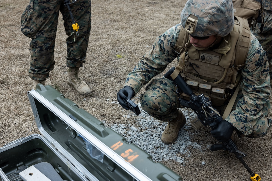 U.S. Marine Corps Staff Sgt. Bryan Bell, a criminal investigator with the 22nd Marine Expeditionary Unit, photographs exploitable material during a simulated raid as part of Marine Air-Ground Task Force (MAGTF) Interoperability Exercise, on Marine Corps Base Camp Lejeune, North Carolina, Feb. 5, 2025. The raid is one of several training events within MAGTF Interoperability, a course conducted by Expeditionary Operations Training Group. This course is designed to evaluate integrated elements of the 22nd MEU across a variety of full mission profiles in a simulated peer threat environment. (U.S. Marine Corps photo by Sgt. Nathan Mitchell)
