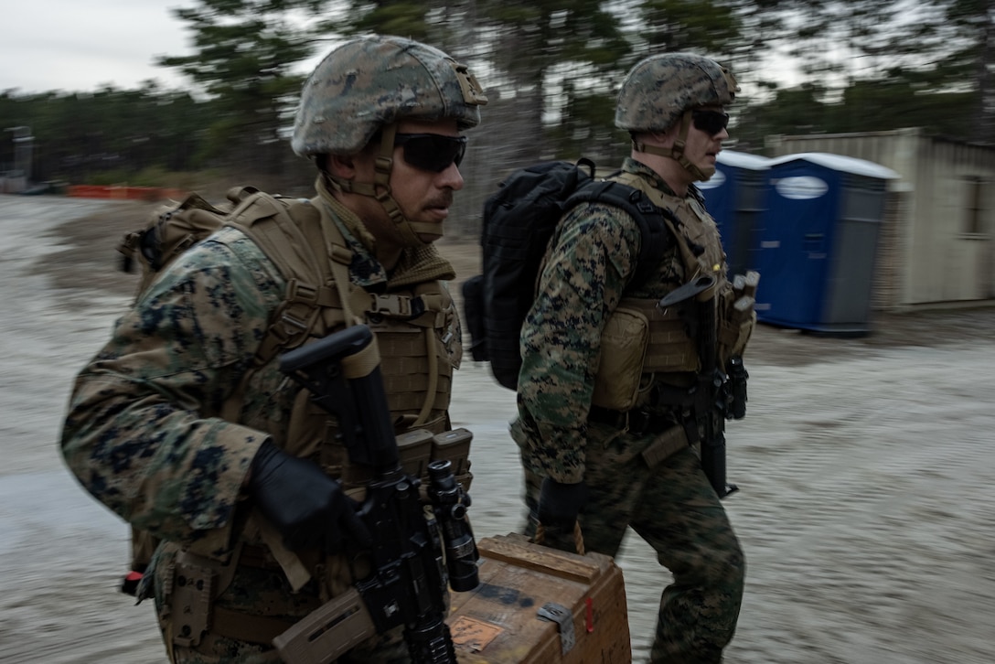U.S. Marine Corps Staff Sgt. Bryan Bell, left, and Staff Sgt. Kevin Allen, both criminal investigators with the 22nd Marine Expeditionary Unit, seize improvised explosive munitions during a simulated raid as part of Marine Air-Ground Task Force (MAGTF) Interoperability Exercise, on Marine Corps Base Camp Lejeune, North Carolina, Feb. 5, 2025. The raid is one of several training events within MAGTF Interoperability, a course conducted by Expeditionary Operations Training Group. This course is designed to evaluate integrated elements of the 22nd MEU across a variety of full mission profiles in a simulated peer threat environment. (U.S. Marine Corps photo by Sgt. Nathan Mitchell)
