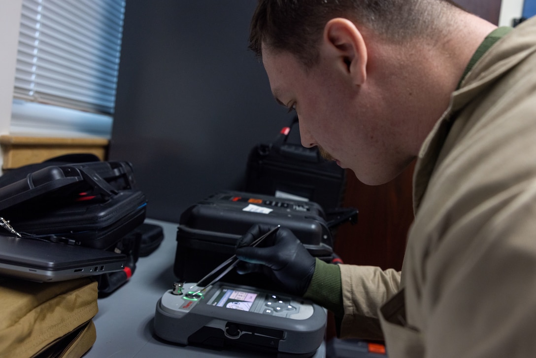 U.S. Marine Corps Staff Sgt. Kevin Allen, a criminal investigator with the 22nd Marine Expeditionary Unit, tests the chemical composition of a sample taken from a simulated raid as part of Marine Air-Ground Task Force (MAGTF) Interoperability Exercise, on Marine Corps Base Camp Lejeune, North Carolina, Feb. 6, 2025. The raid is one of several training events within MAGTF Interoperability, a course conducted by Expeditionary Operations Training Group. This course is designed to evaluate integrated elements of the 22nd MEU across a variety of full mission profiles in a simulated peer threat environment. (U.S. Marine Corps photo by Sgt. Nathan Mitchell)