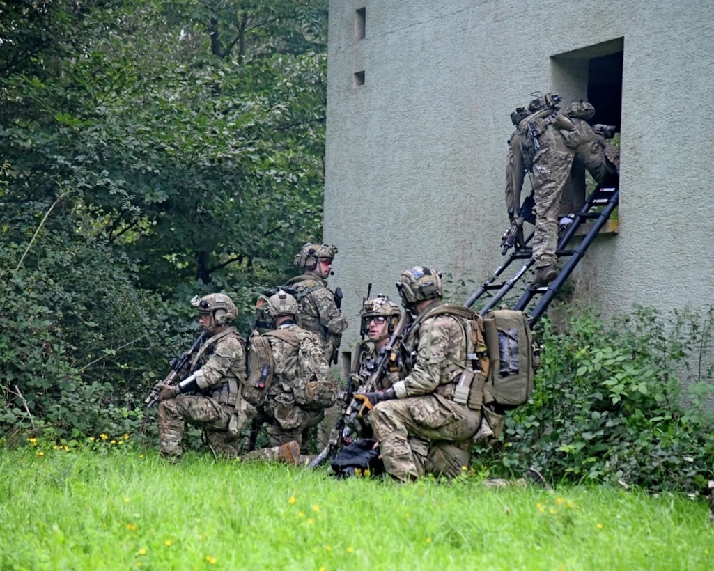 A team of special operations forces enter a second floor window.