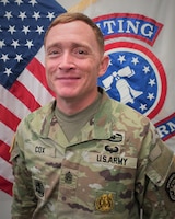 Photo of Command Sgt. Maj. U.S. Army Soldier posing for command photo in front of U.S. flag and United States Recruiting Command (USAREC) flag.