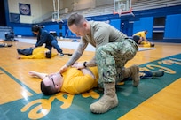 SurgeMain Sailors practice basic lifesaving techniques within a simulated combat environment during a Tactical Combat Casualty Care course Feb. 2, 2025, kicking off their special two-week annual training program on Naval Base Kitsap-Bremerton, Washington. (Navy photo by MC1 Jeffrey J. Hanshaw)