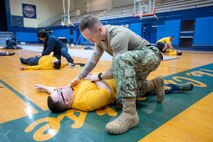 SurgeMain Sailors practice basic lifesaving techniques within a simulated combat environment during a Tactical Combat Casualty Care course Feb. 2, 2025, kicking off their special two-week annual training program on Naval Base Kitsap-Bremerton, Washington. (Navy photo by MC1 Jeffrey J. Hanshaw)