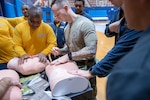 SurgeMain Sailors practice the procedure for inserting a large-bore needle in order to decompress a simulated tension pneumothorax Feb. 2, during Tactical Combat Casualty Care training on Naval Base Kitsap-Bremerton, Washington. The program helped kick off the SurgeMain Sailors' annual two-week training deployment at Puget Sound Naval Shipyard & Intermediate Maintenance Facility. Established in 2005, SurgeMain has more than 2,000 Reserve Sailors across 75 units. (U.S. Navy photo by MC1 Jeffrey J. Hanshaw)