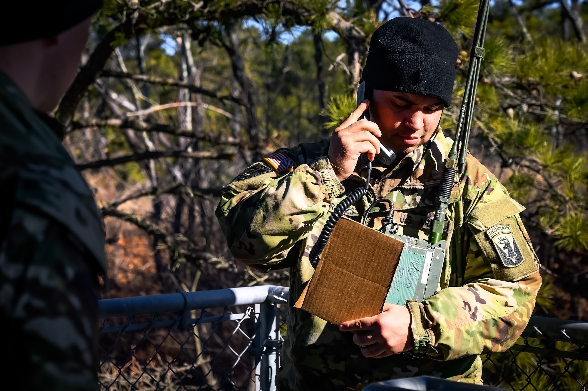 U.S. Army Sgt. Javier Morales, 1-102nd Infantry Regiment infantryman, tests a tactical single channel radio during a platoon live-fire exercise at Joint Base McGuire-Dix-Lakehurst, N.J., Feb. 1, 2025. The platoon live-fire exercise incorporated land navigation through indirect fire and utilized unmanned aerial vehicle systems for both reconnaissance and offensive maneuvers. (U.S. Air Force photo by Senior Airman Matt Porter)