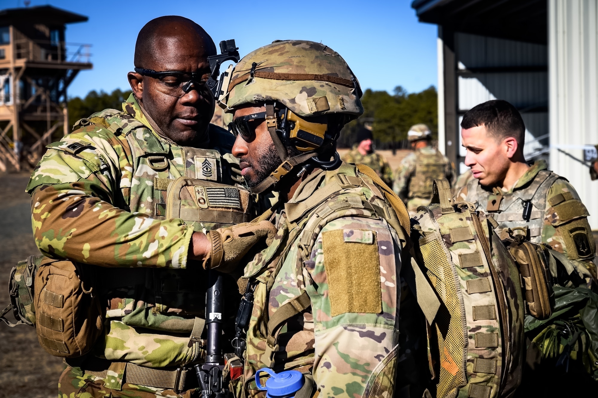 U.S. Army 1st Sgt. Gregory Reid, 1-102nd Infantry Regiment infantryman, performs a gear inspection during a live-fire exercise at Joint Base McGuire-Dix-Lakehurst, N.J., Feb. 1, 2025. The platoon live-fire exercise incorporated land navigation through indirect fire and utilized unmanned aerial vehicle systems for both reconnaissance and offensive maneuvers. (U.S. Air Force photo by Senior Airman Matt Porter)