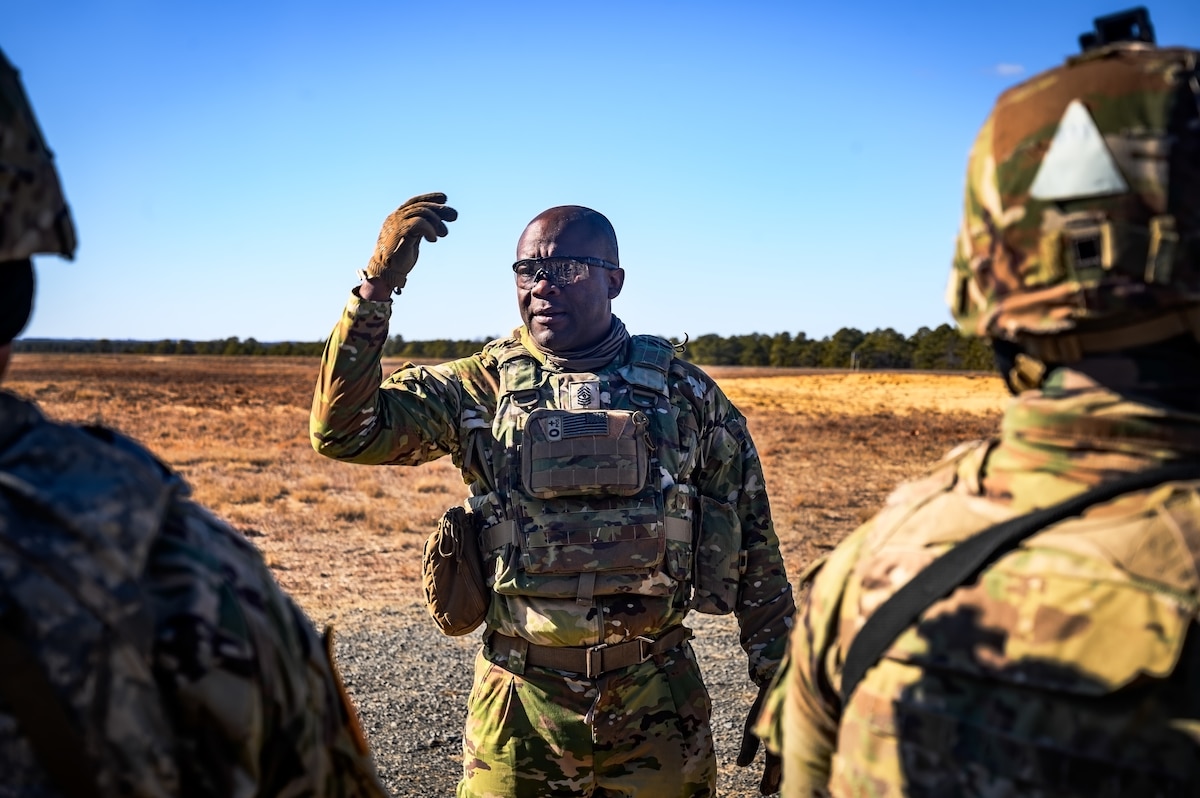 U.S. Army 1st Sgt. Gregory Reid, 1-102nd Infantry Regiment infantryman, gives instruction during a platoon live-fire exercise at Joint Base McGuire-Dix-Lakehurst, N.J., Feb. 1, 2025. The platoon live-fire exercise incorporated land navigation through indirect fire and utilized unmanned aerial vehicle systems for both reconnaissance and offensive maneuvers. (U.S. Air Force photo by Senior Airman Matt Porter)