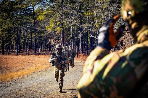 U.S. Army Soldiers assigned to the 1-102nd Infantry Regiment regroup during a platoon live-fire exercise at Joint Base McGuire-Dix-Lakehurst, N.J., Feb, 1 2025. The platoon live-fire exercise incorporated land navigation through indirect fire and utilized unmanned aerial vehicle systems for both reconnaissance and offensive maneuvers. (U.S. Air Force photo by Senior Airman Matt Porter)