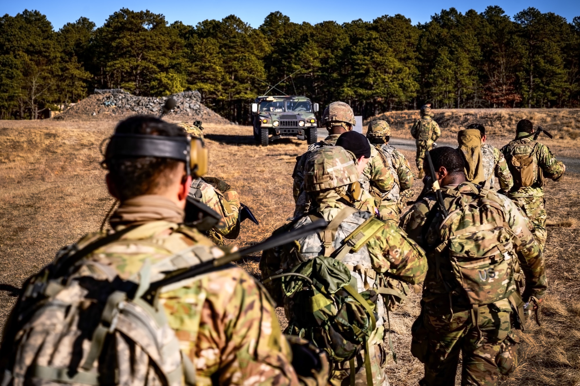 U.S. Army Soldiers assigned to the 1-102nd Infantry Regiment regroup during a platoon live-fire exercise at Joint Base McGuire-Dix-Lakehurst, N.J., Feb. 1, 2025. The platoon live-fire exercise incorporated land navigation through indirect fire and utilized unmanned aerial vehicle systems for both reconnaissance and offensive maneuvers. (U.S. Air Force photo by Senior Airman Matt Porter)