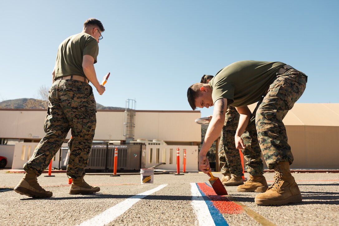 U.S. Marines with School of Infantry-West, Training Command, repaint parking and no-parking lines during Semper Tergeo at Marine Corps Base Camp Pendleton, Calif., Feb. 24, 2025. Semper Tergeo aims to support operational readiness and increase safety for the operating forces, tenant commands, service members and families by effectively policing and maintaining the various areas of Camp Pendleton. (U.S. Marine Corps photo Sgt. Patrick King)