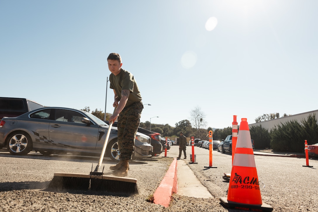 U.S. Marine Corps Pfc. Skyler Cuffel, a Kansas native and automotive maintenance technician with School of Infantry-West, Training Command, sweeps during Semper Tergeo at Marine Corps Base Camp Pendleton, Calif., Feb. 24, 2025. Semper Tergeo aims to support operational readiness and increase safety for the operating forces, tenant commands, service members and families by effectively policing and maintaining the various areas of Camp Pendleton. (U.S. Marine Corps photo Sgt. Patrick King)