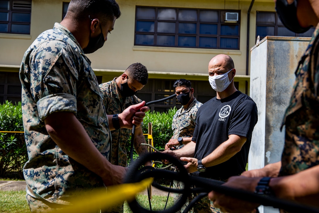 U.S. Marines participate in tactical rope suspension training during the Enhanced Squad Leader Course, Marine Corps Base Hawaii, April 15, 2021. This portion of the course exposes and familiarizes Marines with techniques that can be utilized to navigate mountainous terrain. (U.S. Marine Corps photo by Lance Cpl. Samantha Sanchez)