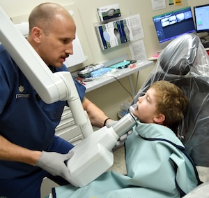 child receives x-rays from dentist