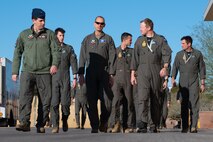 U.S. Air Force Maj. Gen. Christopher Niemi, center, U.S. Air Force Warfare Center commander, discusses a recent Joint Integrated Test and Training Center-Nellis (JITTC-N) milestone with Lt. Col. Shain Bestick, left, 31st Combat Training Squadron, JITTC-N commander, and Royal Australian Air Force (RAAF) Wing Commander Ben Sawley, 77 Squadron commanding officer at Nellis Air Force Base, Nevada, Feb. 20, 2025.