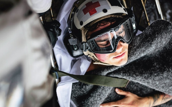 Sailors carry Intelligence Specialist 2nd Class Isaac Eaker, assigned to intelligence department’s satellite imagery analyzation division, to elevator on flight deck during medical drill aboard aircraft carrier USS George Washington while underway in Pacific Ocean, November 11, 2024