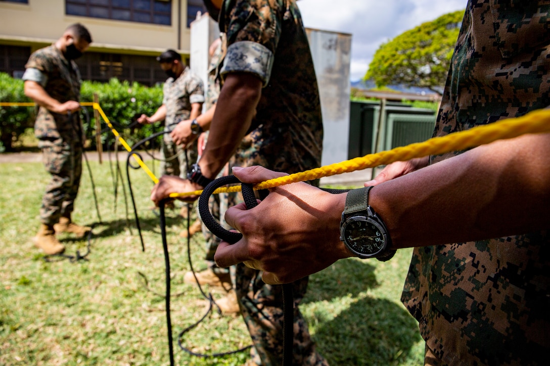 U.S. Marines participate in tactical rope suspension training during the Enhanced Squad Leader Course, Marine Corps Base Hawaii, April 15, 2021. This portion of the course exposes and familiarizes Marines with techniques that can be utilized to navigate mountainous terrain. (U.S. Marine Corps photo by Lance Cpl. Samantha Sanchez)