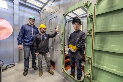 Southwest Regional Apprentice Program instructors (from left) Erik Hughes, Shop 38, Marine Machinist; Andrew Fernandez, Code 740, Riggers; and Enrellee Thomas, Shop 26, Welders, pose for photo, Jan. 23, 2025, inside the program's new training facility at Naval Air Station North Island, San Diego. (U.S. Navy photo by Jeb Fach)