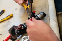 U.S. Air Force Staff Sgt. Shawn Powers, 9th Maintenance Air Force Repair Enhancement Program (AFREP) technician, repairs a T-38 Talon stick grip at Beale Air Force Base, California, Feb. 4, 2025.