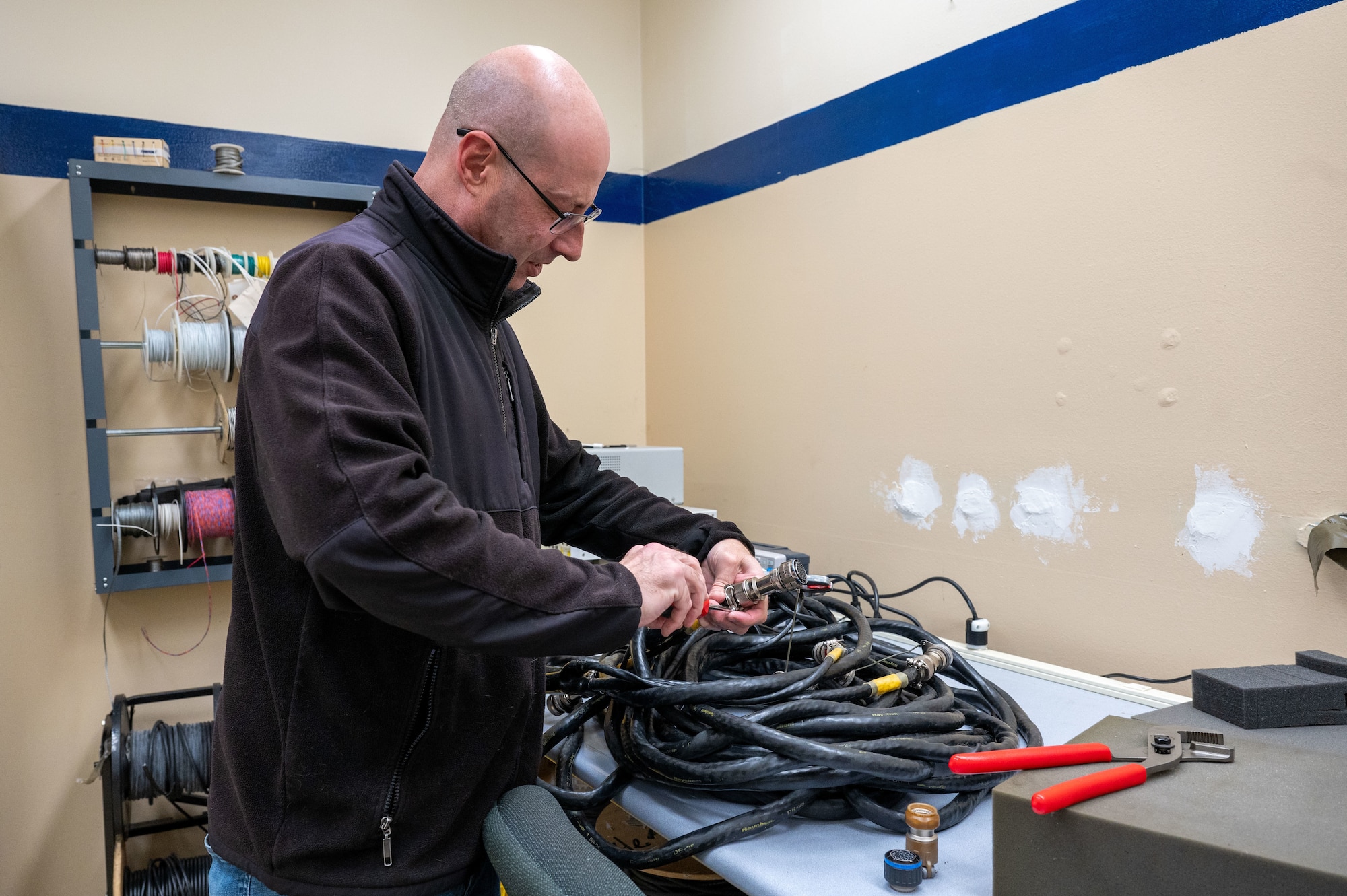 Brian Moebs, Air Force Repair Enhancement Program (AFREP) technician, repairs an engine cable at Beale Air Force Base, California, Jan. 27, 2025.