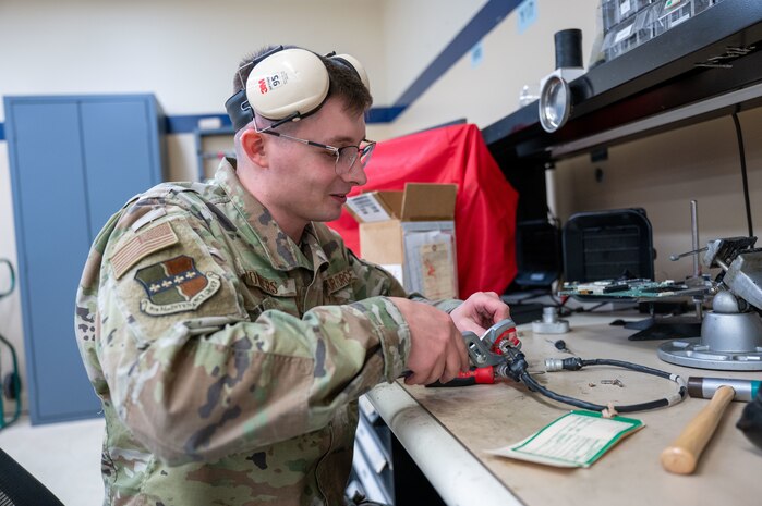 U.S. Air Force Staff Sgt. Shawn Powers, 9th Maintenance Air Force Repair Enhancement Program (AFREP) technician, assesses a splitter cable for damage at Beale Air Force Base, California, Jan. 27, 2025.