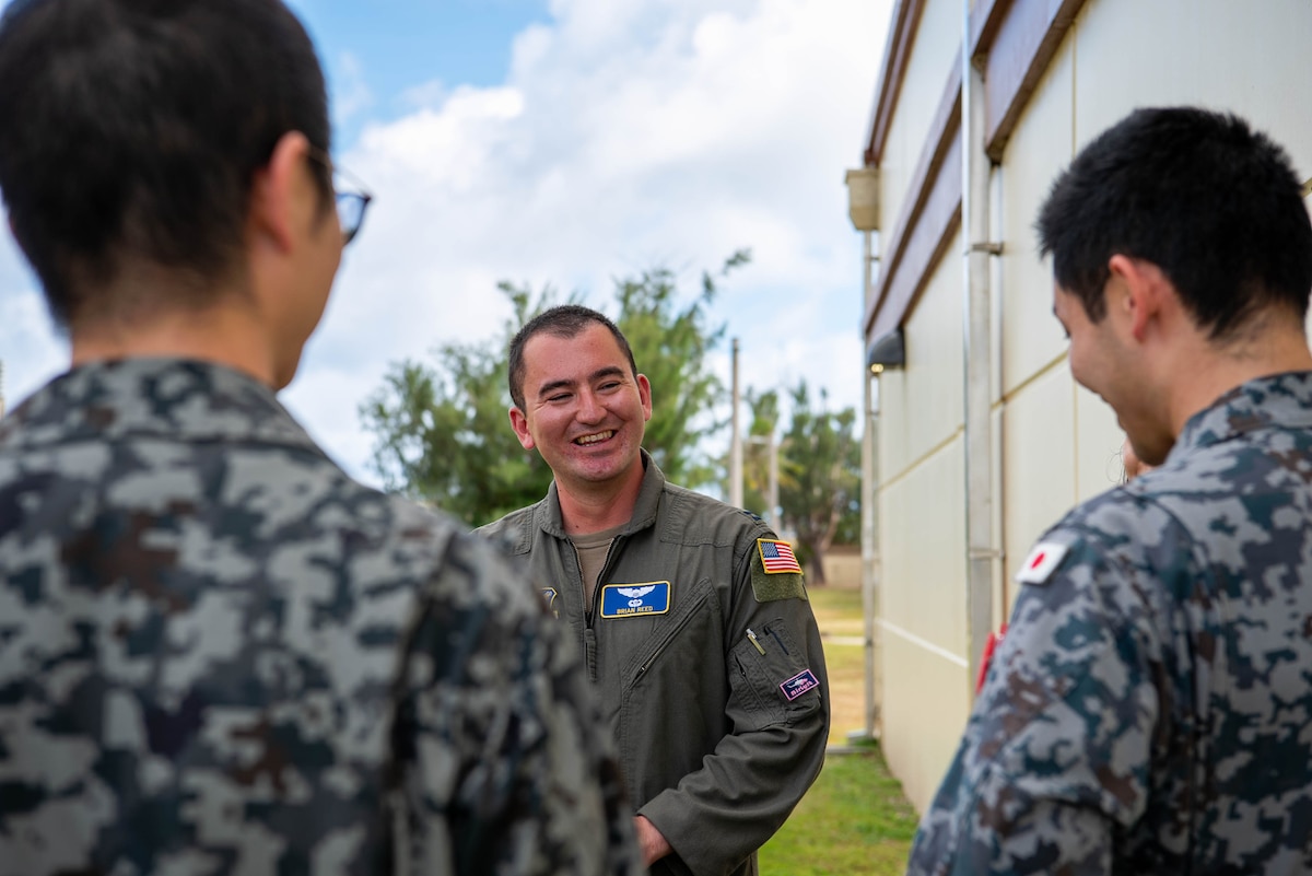 U.S. Air Force Capt. Brian Reed, 374th Operations Group deputy chief of group standardization and evaluation, speaks with Japan Air Self-Defense Force members in Japanese during exercise Cope North 25 on Andersen Air Force Base, Guam, Feb. 19, 2025.