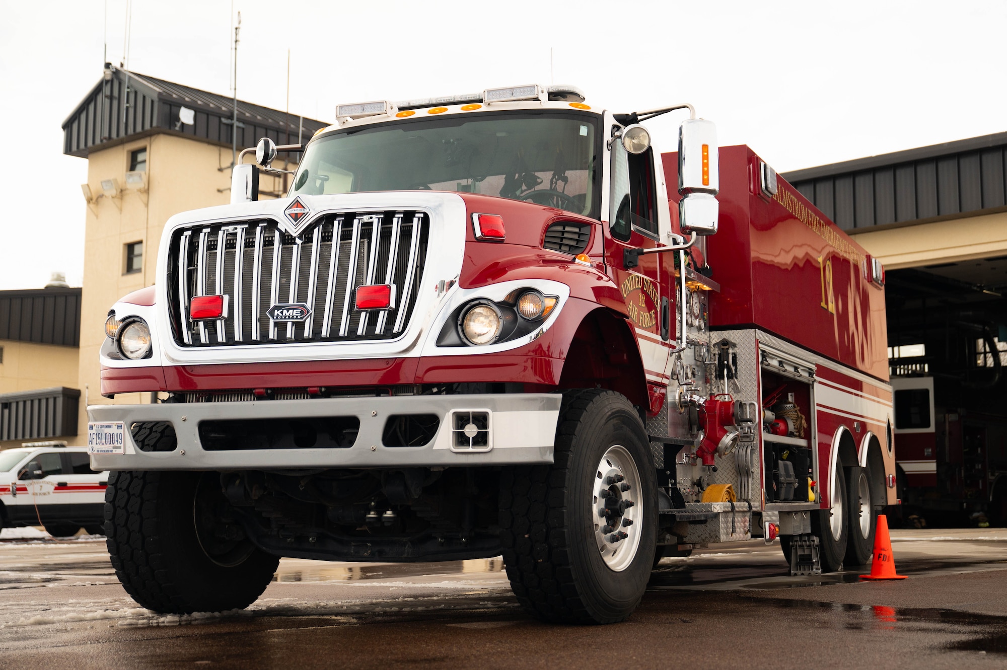 A man in uniform works on a fire truck.