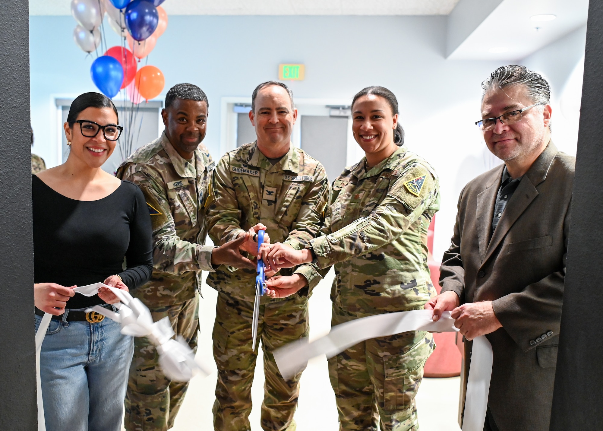A Pacific Coast Center community center recreations assistant (left), a Space Launch Delta 30 senior enlisted leader (middle left), a SLD 30 commander (middle), 30th Force Support Squadron commander (middle right) and PCC club manager, pose for a photo during the PCC gaming room grand opening at Vandenberg Space Force Base.